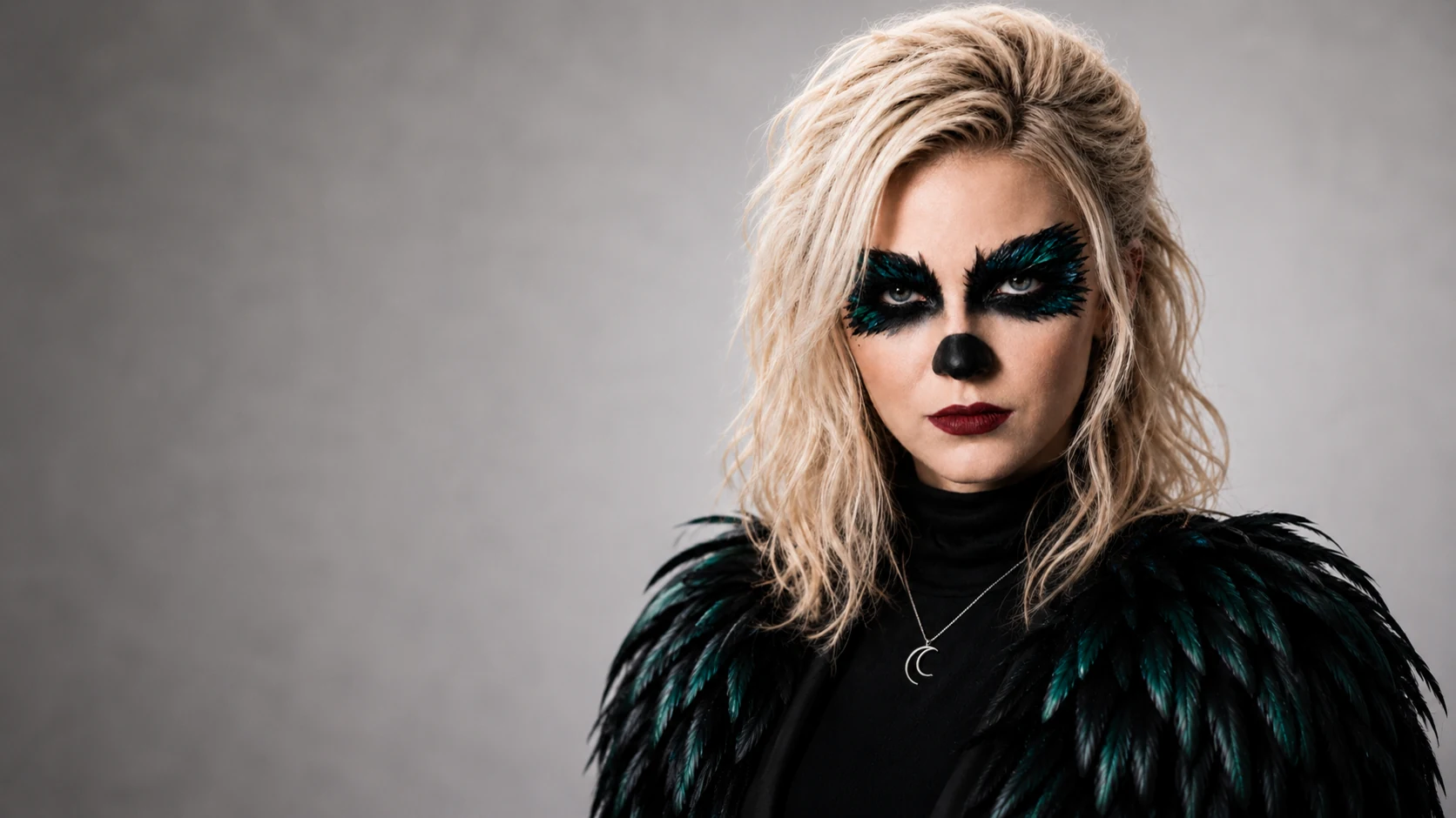 Clarapetra in the Pretty Machine era, wearing black feathers and teal raven-inspired makeup against a pale studio background.